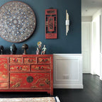Marble cylinder sconce glowing in a softly lit living space
