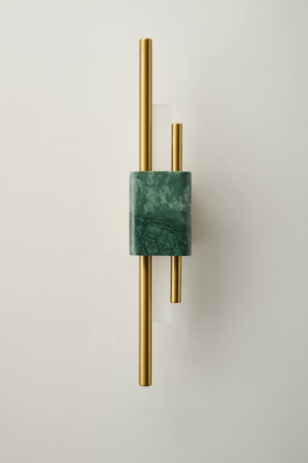 White marble wall sconce illuminating a refined entryway
