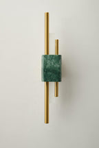 White marble wall sconce illuminating a refined entryway