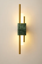 Green marble cylinder wall lamp with a warm ambient glow