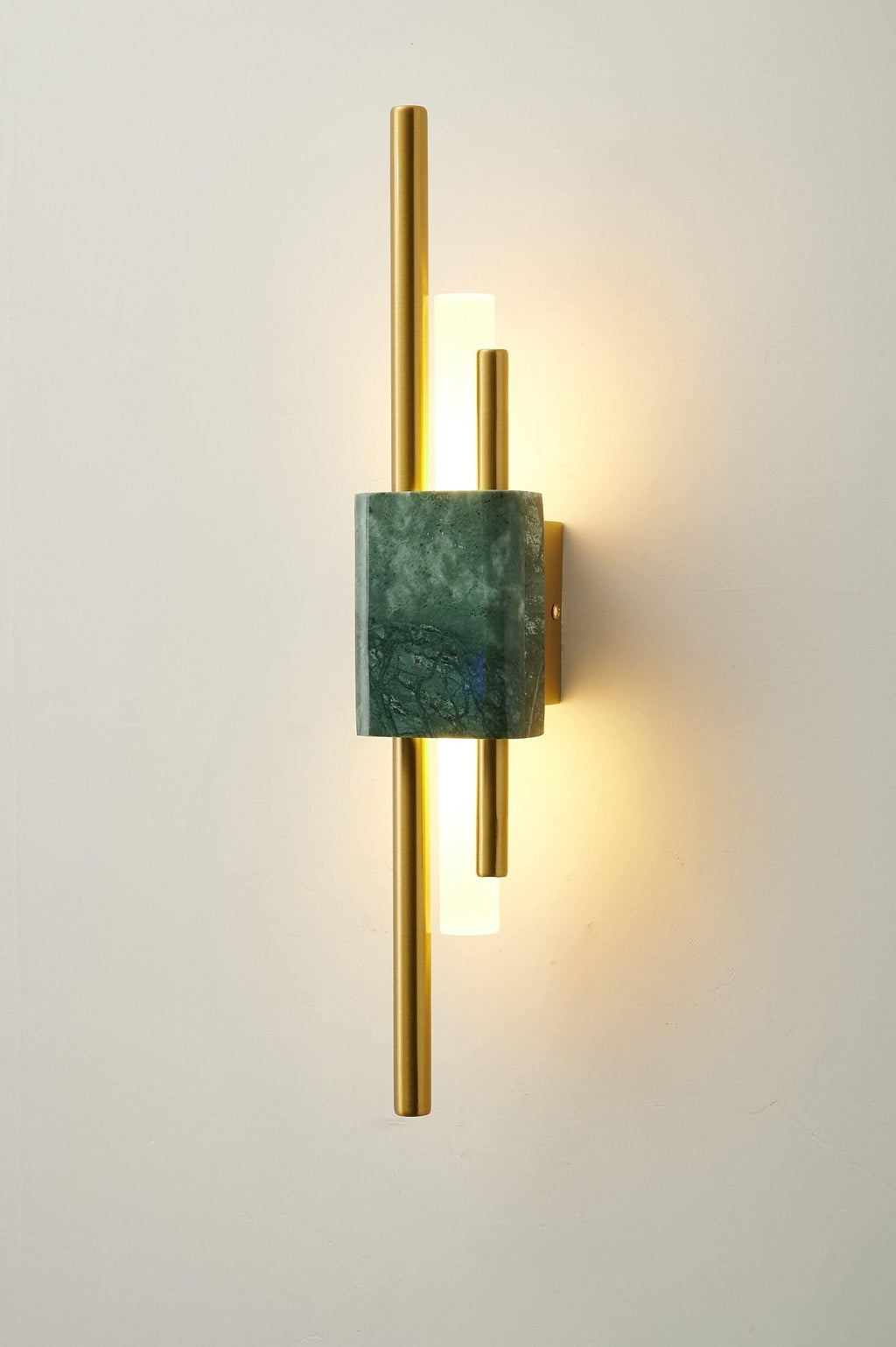 White marble and gold sconce lighting a minimal interior