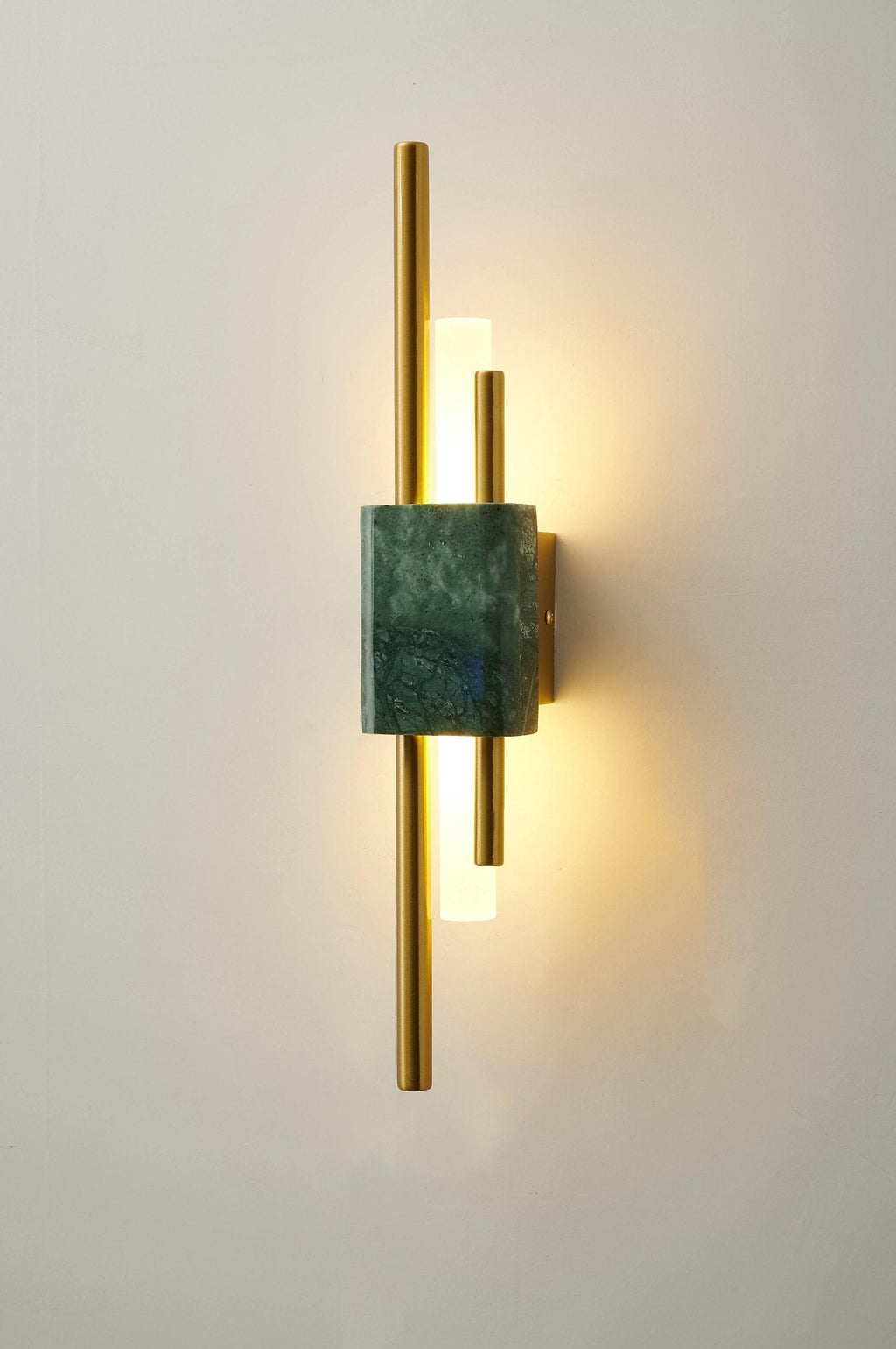 Marble wall lamp glowing warmly beside a wooden console