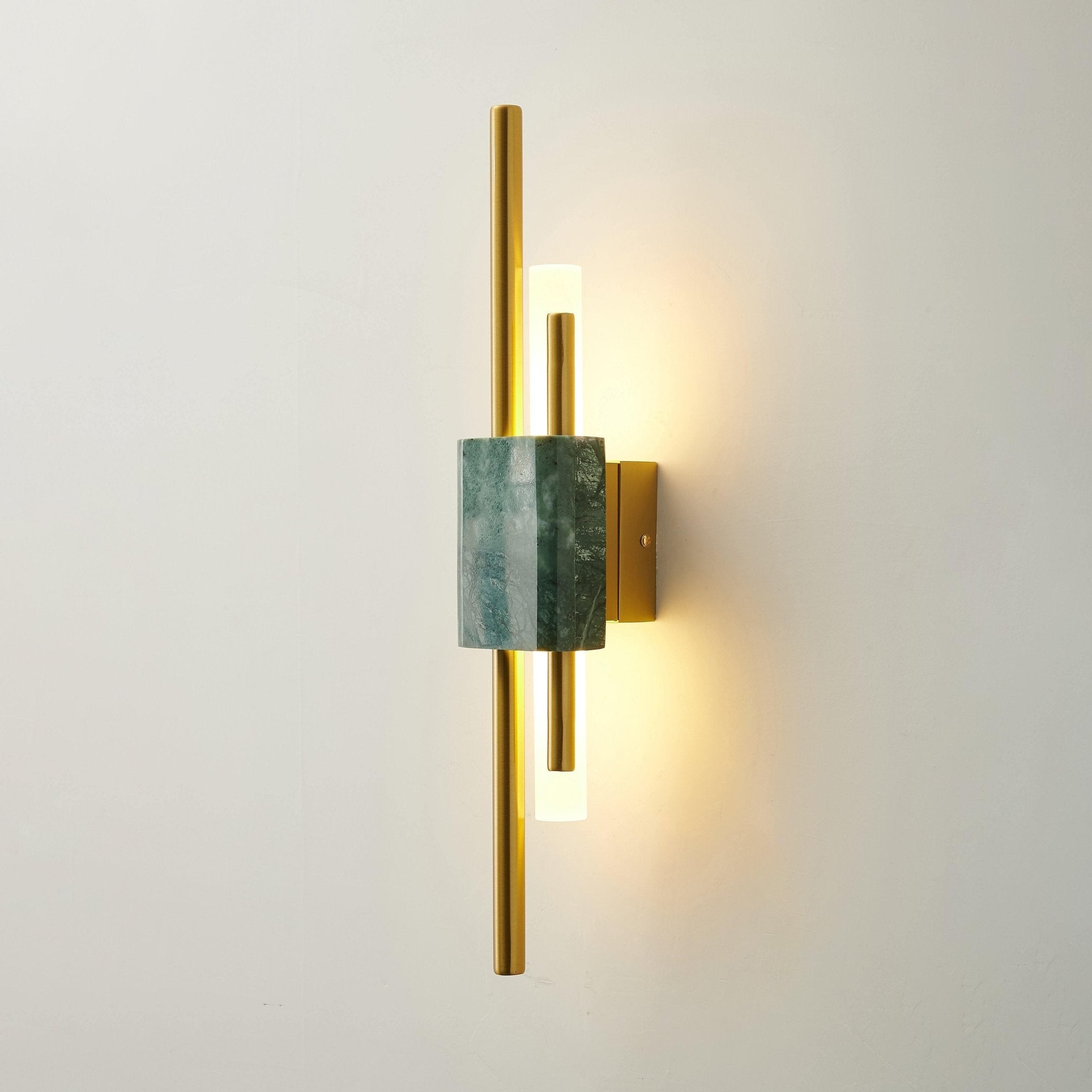 Green marble wall lamp glowing softly in a styled interior