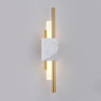 Green marble wall lamp with gold trim mounted on a wall