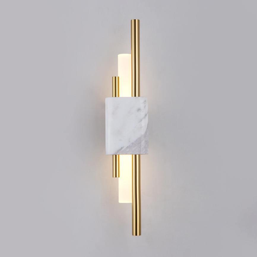Green marble wall lamp with gold trim mounted on a wall