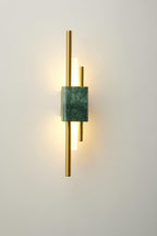 Green marble wall sconce with gold base on a styled wall