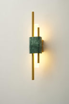 A slightly different crop of the same Clérachic wall sconce, green marble front lit against a cream wall.