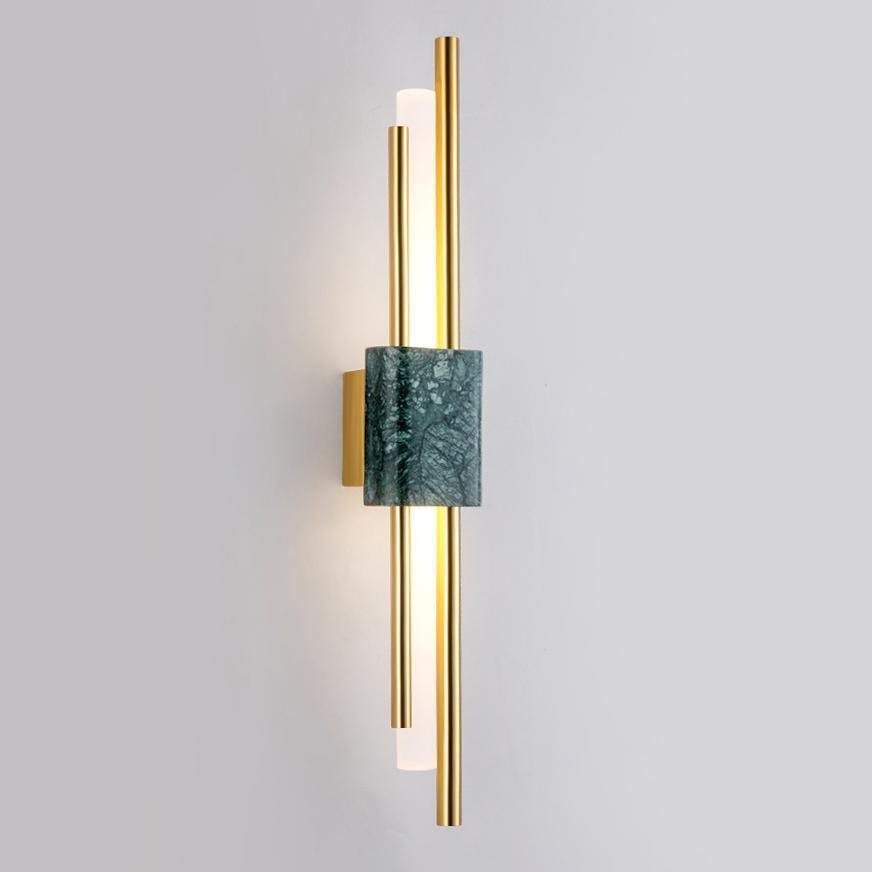 White marble wall sconce casting soft warm light at night