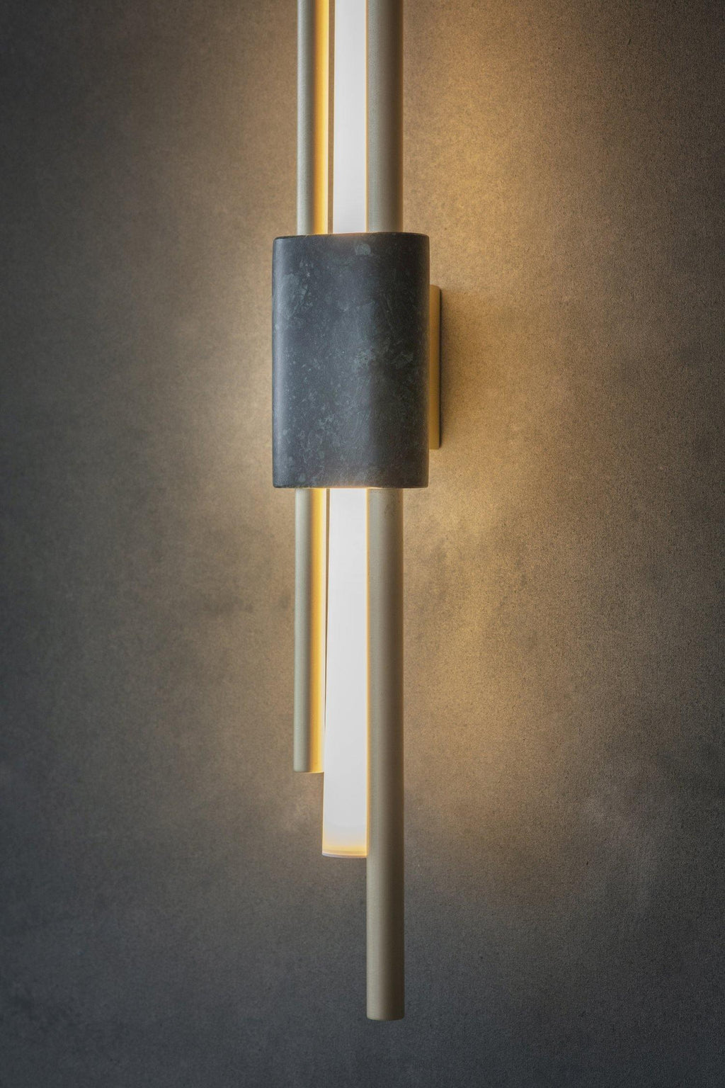 White marble wall lamp detail showing polished stone surface