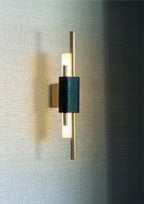Marble cylinder wall lamp lighting a hallway with warm glow