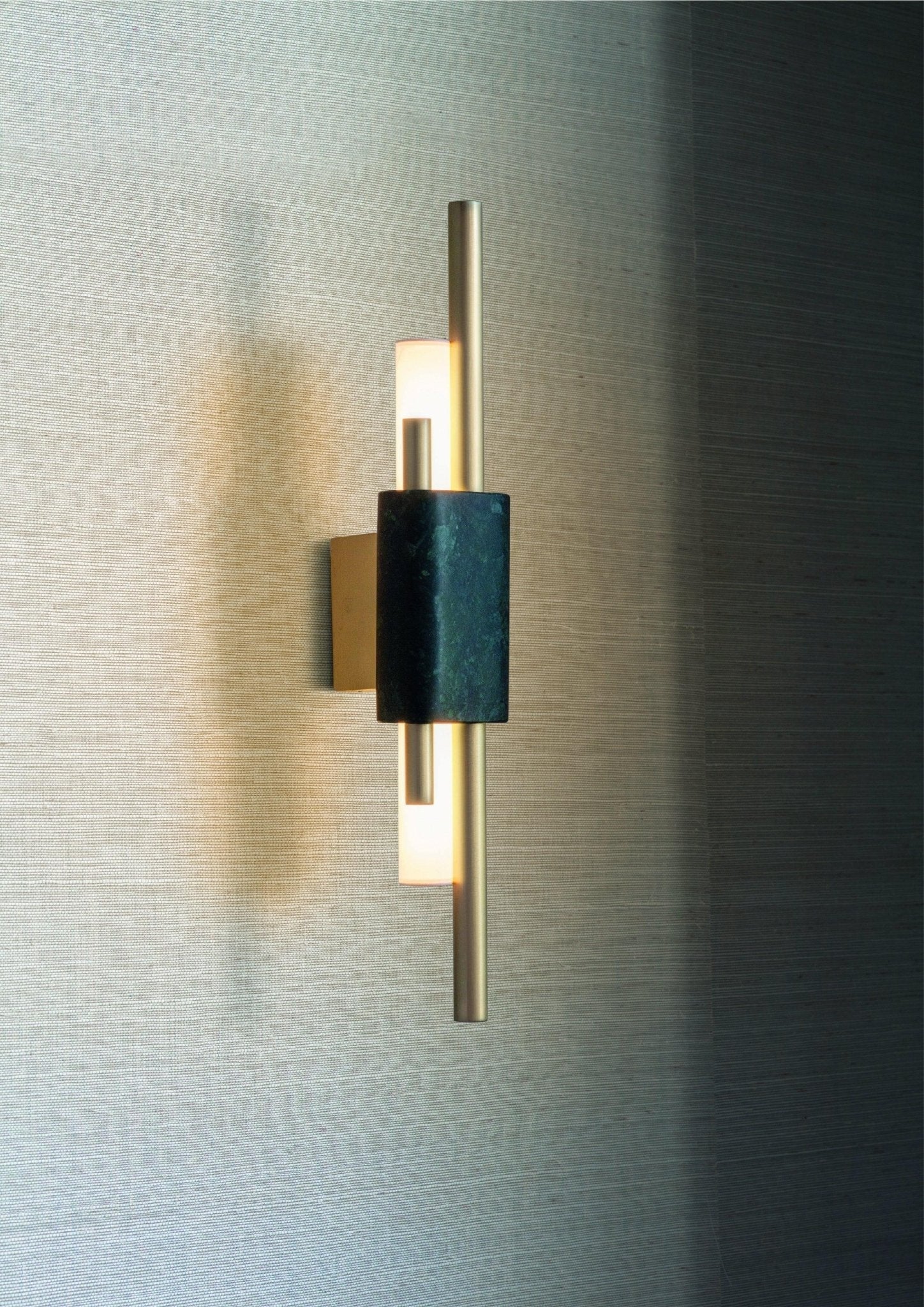 Marble cylinder wall lamp lighting a hallway with warm glow