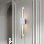 A white marble block anchors this Clérachic wall light, mounted in a plastered archway beside a column and a small bust.