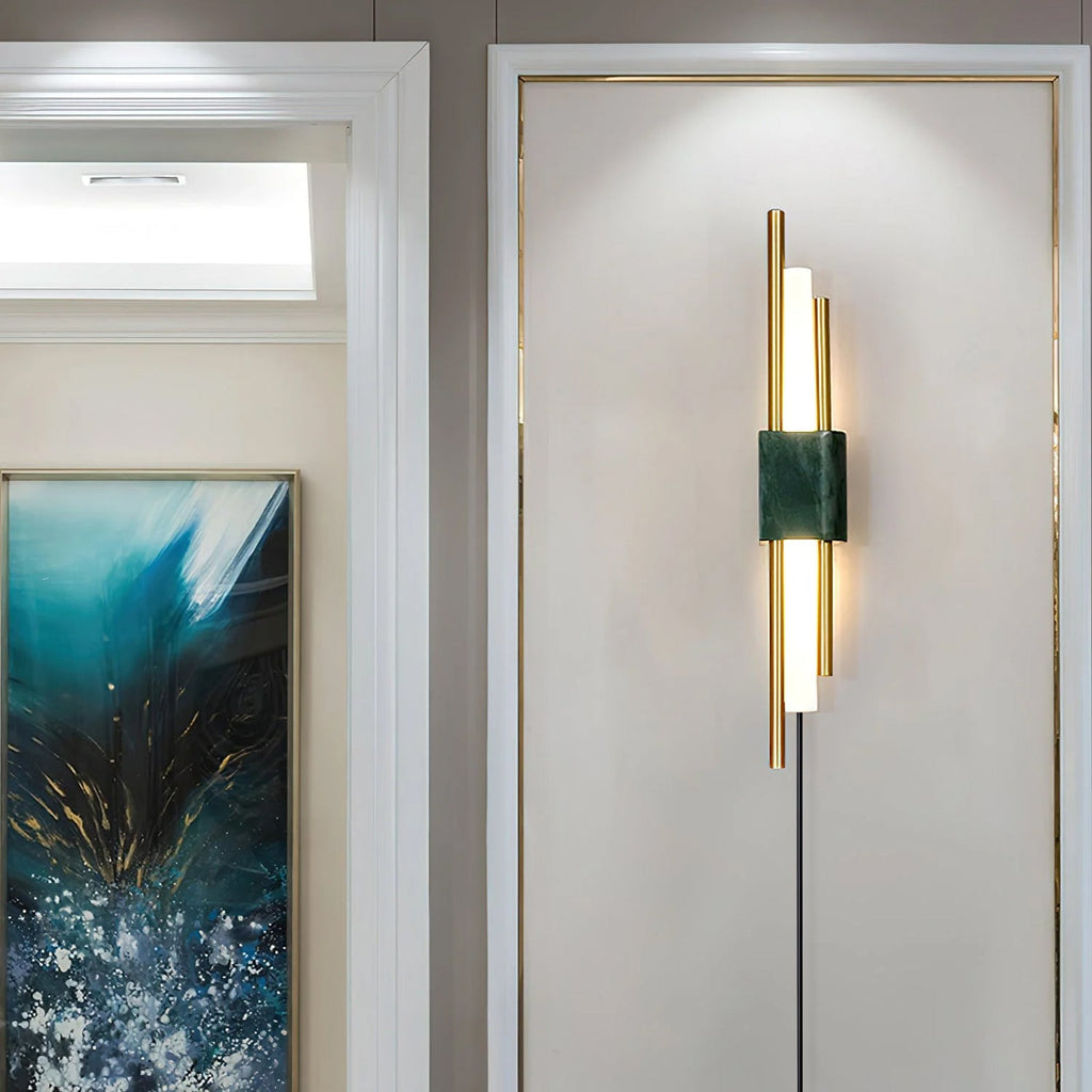 Clérachic brass-rod wall light with a white marble block hangs in a hallway lined with a blue abstract painting and a skylight.