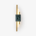 Green marble cylinder sconce illuminating a bedroom corner