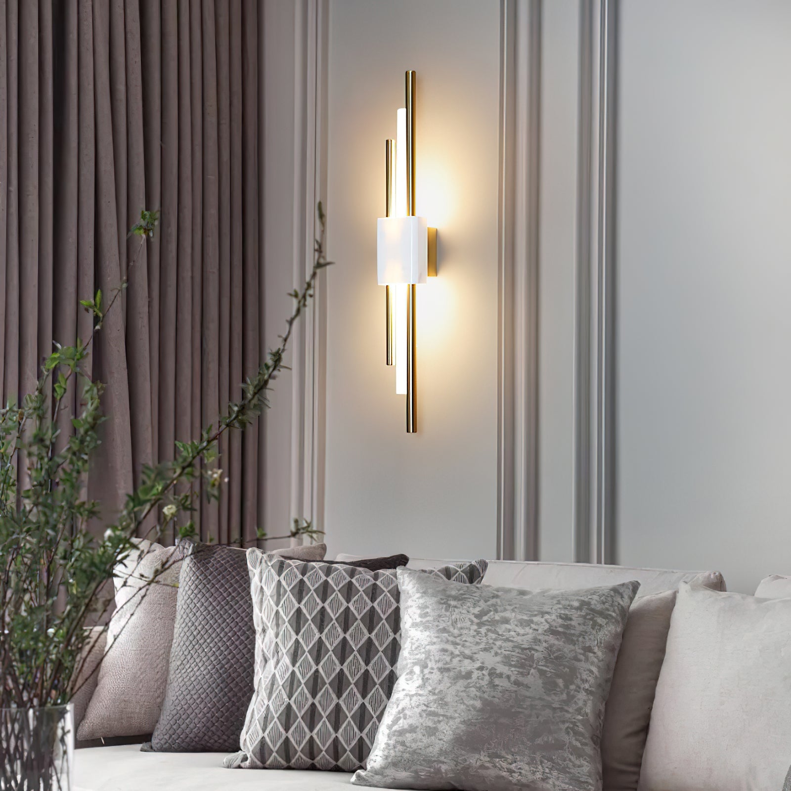 Marble and gold wall lamp mounted beside a bedroom headboard