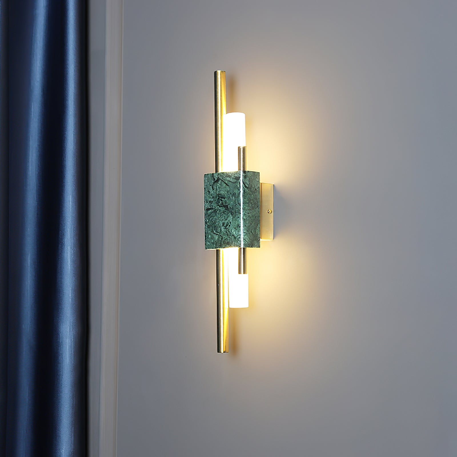 Marble wall lamp detail showing gold base and warm glow