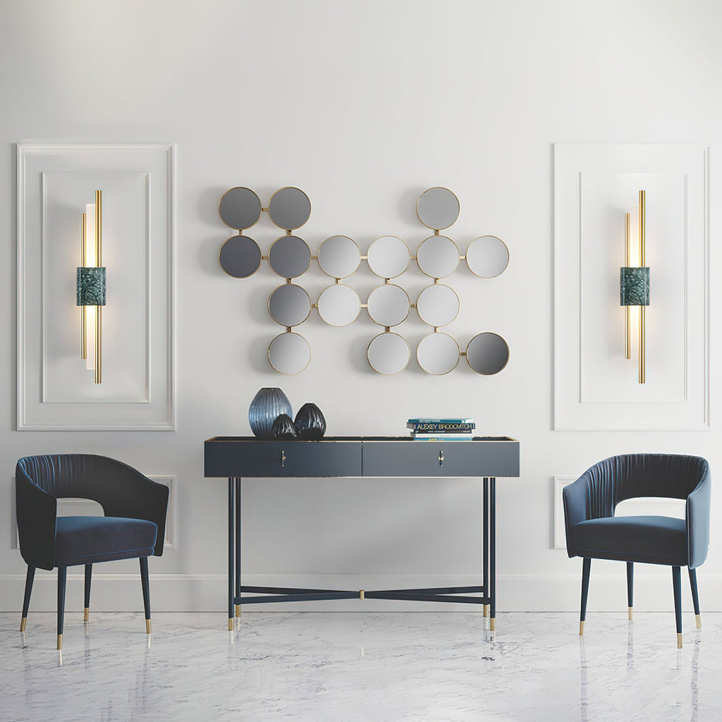 White marble cylinder wall lamp on a textured plaster wall