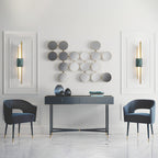 White marble cylinder wall lamp on a textured plaster wall