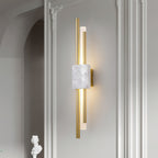 Clérachic wall sconce with white marble front lights a plastered archway beside a classical bust, echoing a hallway niche.