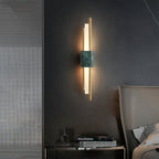 Green marble wall sconce lighting a calm reading nook