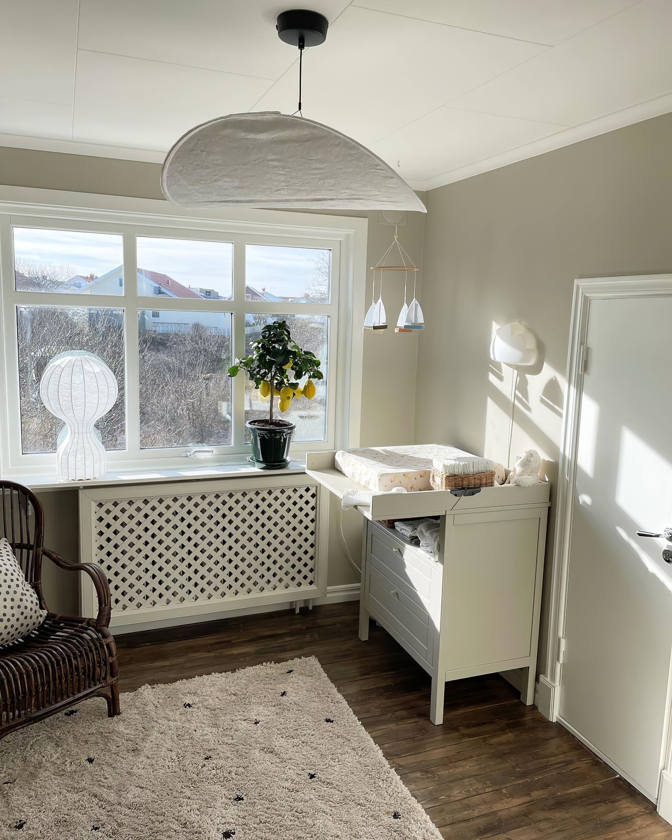 Sculptural Tyvek pendant light hanging in a modern lounge
