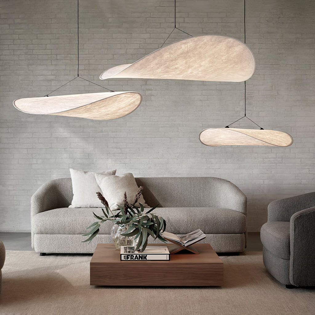 Oversized white paper pendant light above a dining table