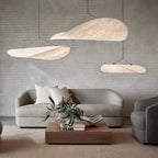Oversized white paper pendant light above a dining table