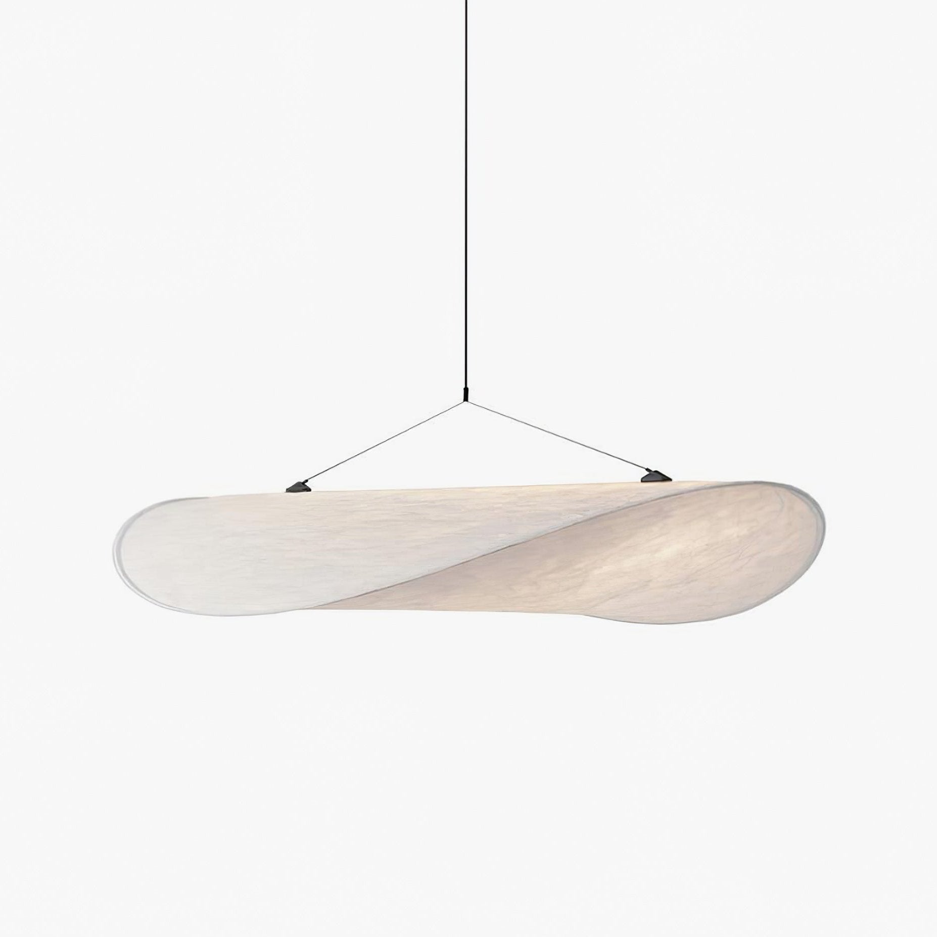 Sculptural paper pendant light hanging in a bright interior