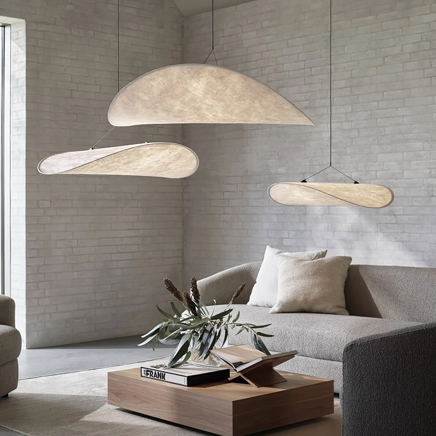Paper pendant lamp with folded shade casting warm light