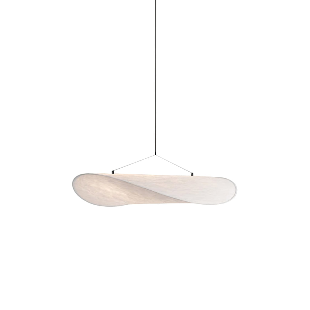 Tense silk pendant light glowing softly above a table