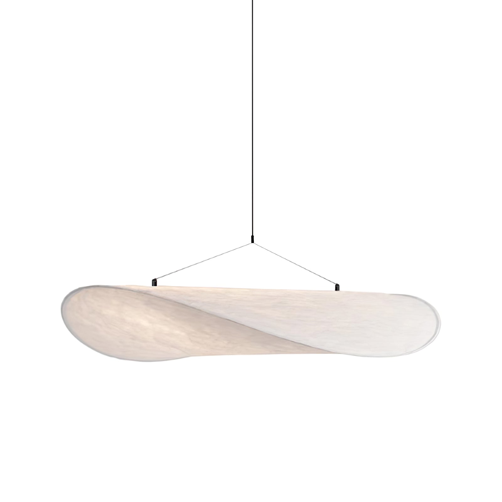 Round silk pendant light glowing warmly in an interior
