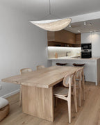 White paper pendant light glowing gently in a modern lounge
