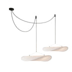 Silk pendant light shown from below with warm glow