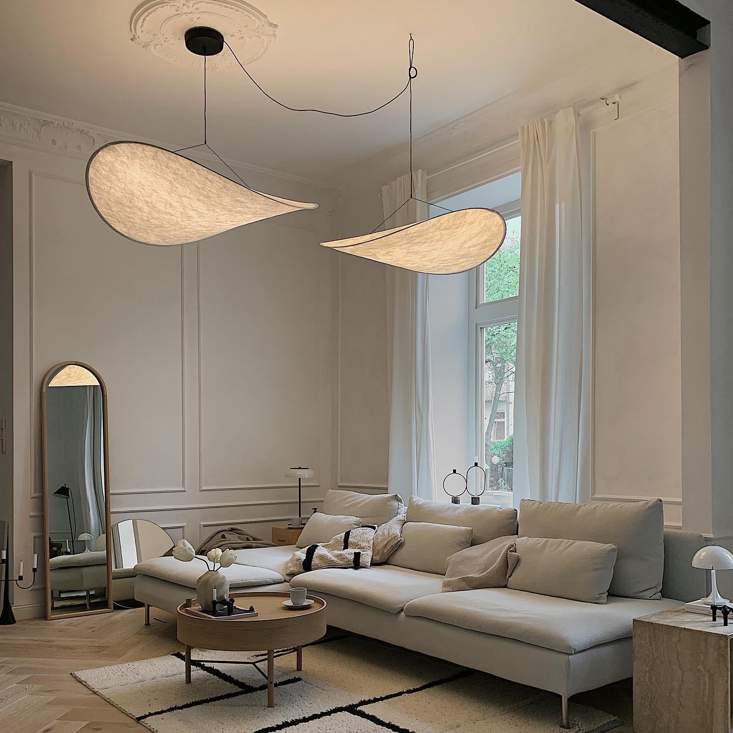 White silk pendant light with even warm glow indoors
