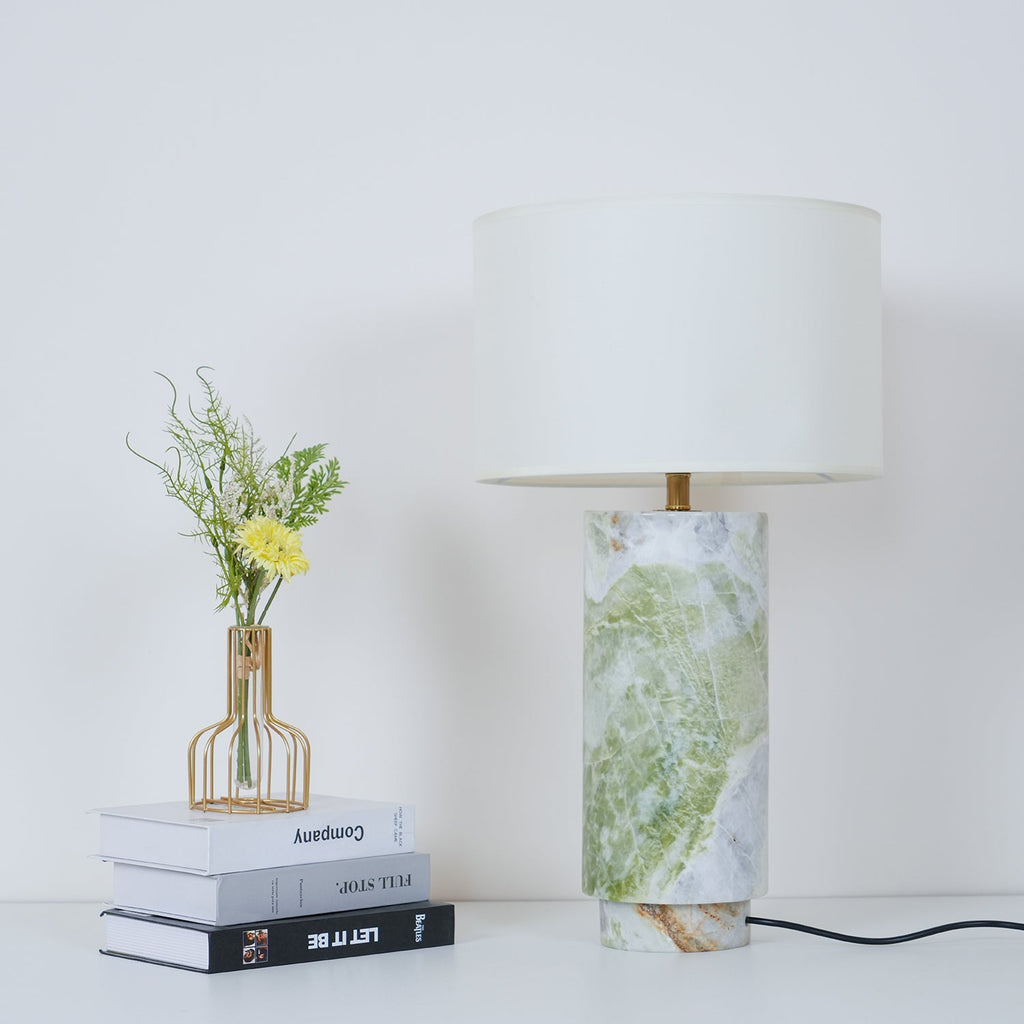Clérachic table lamp shown with extra headroom above the drum shade, books, vase and fern fronds still in frame.