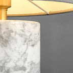 Close-up of the Clérachic table lamp's green marble base, showing the stone's veining and the brass cap at its rim.