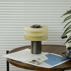 The alabaster lamp switched off in daylight, the discs showing their natural pale cream-and-green tone