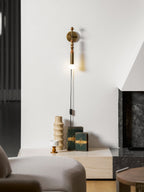 Clérachic wall sconce above a lounge side table near a marble fireplace edge, warm wood beads and a lit globe.