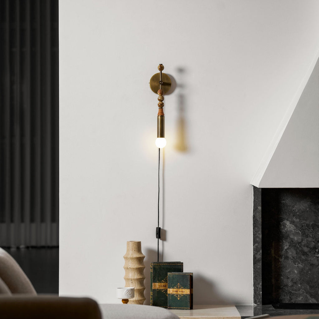 Clérachic wall light in the same lounge setting, wood beads catching the light at a slightly different angle.