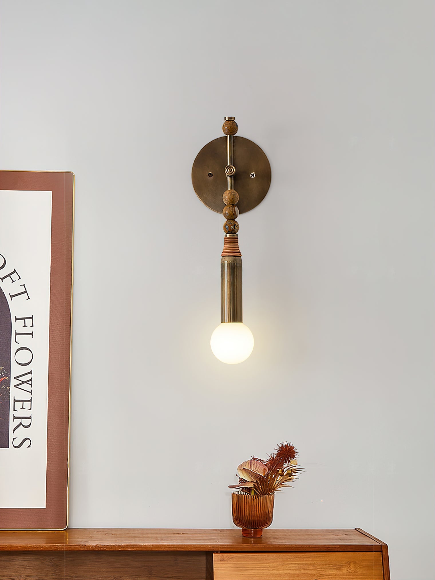 Antique brass and stone wall lamp lighting a styled interior