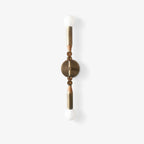 Brass wall lamp with stone base glowing in a quiet corner