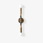 Brass wall sconce with green marble detail in a calm room