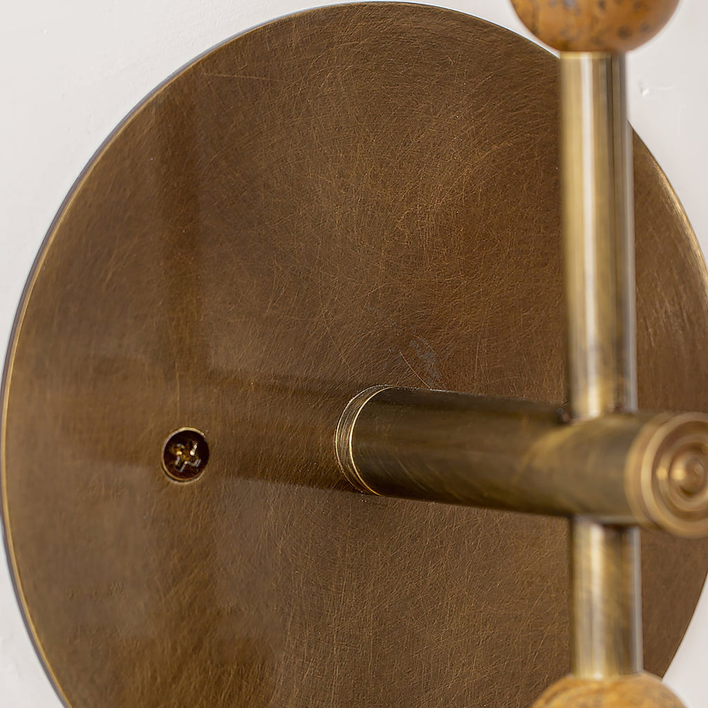 Antique brass wall lamp with stone detail in a soft lit room