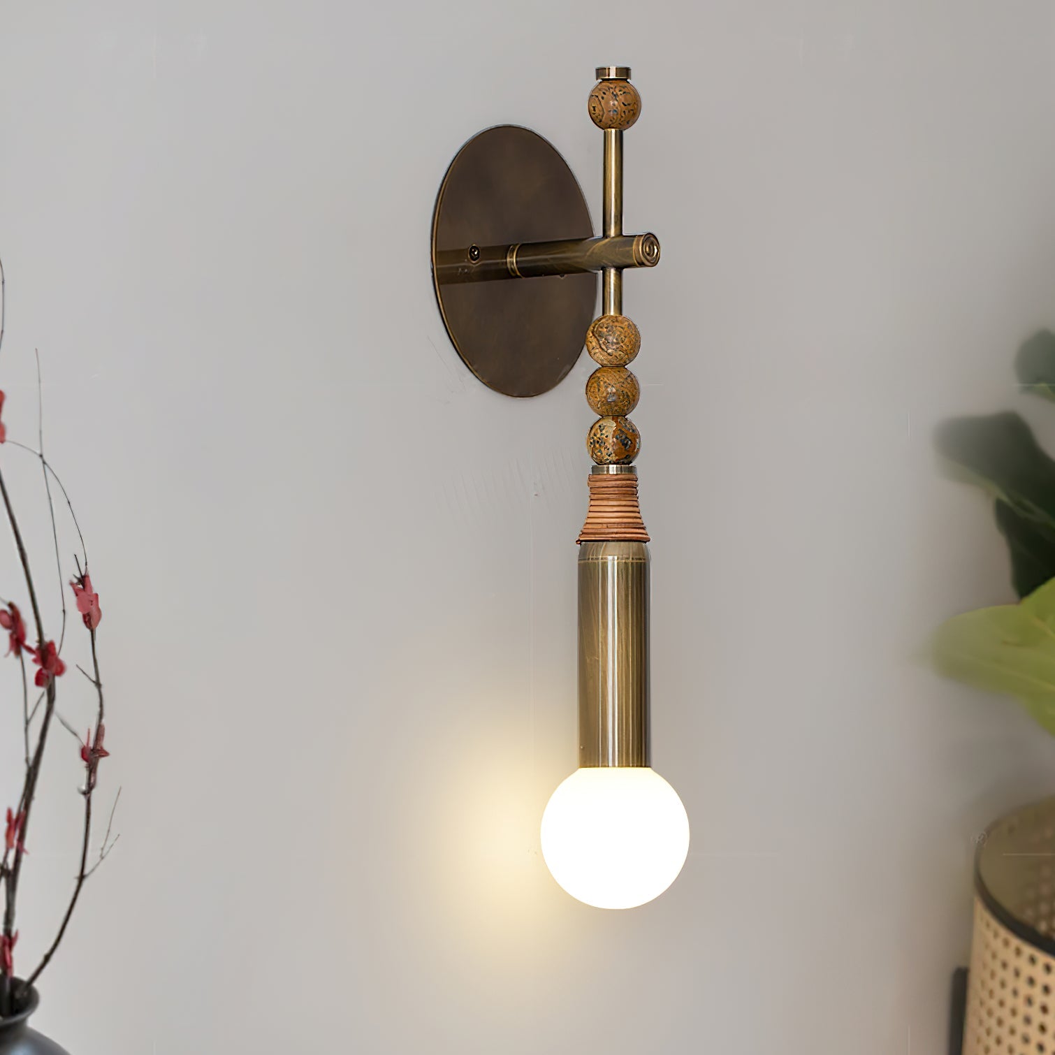 Antique brass wall lamp casting warm light on a bedroom wall