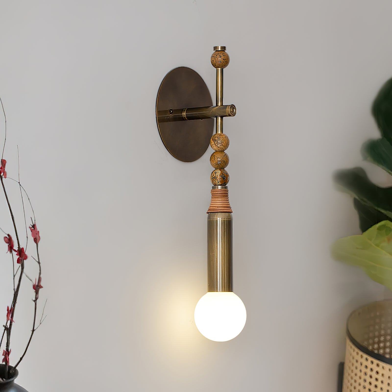 Brass and marble wall lamp glowing softly in a hallway