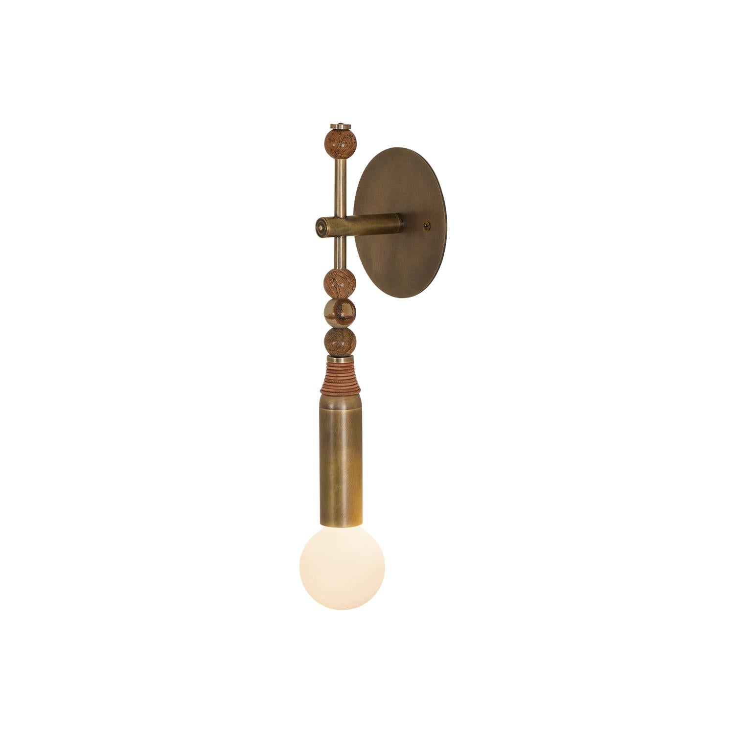 Antique brass and white marble wall lamp casting warm light