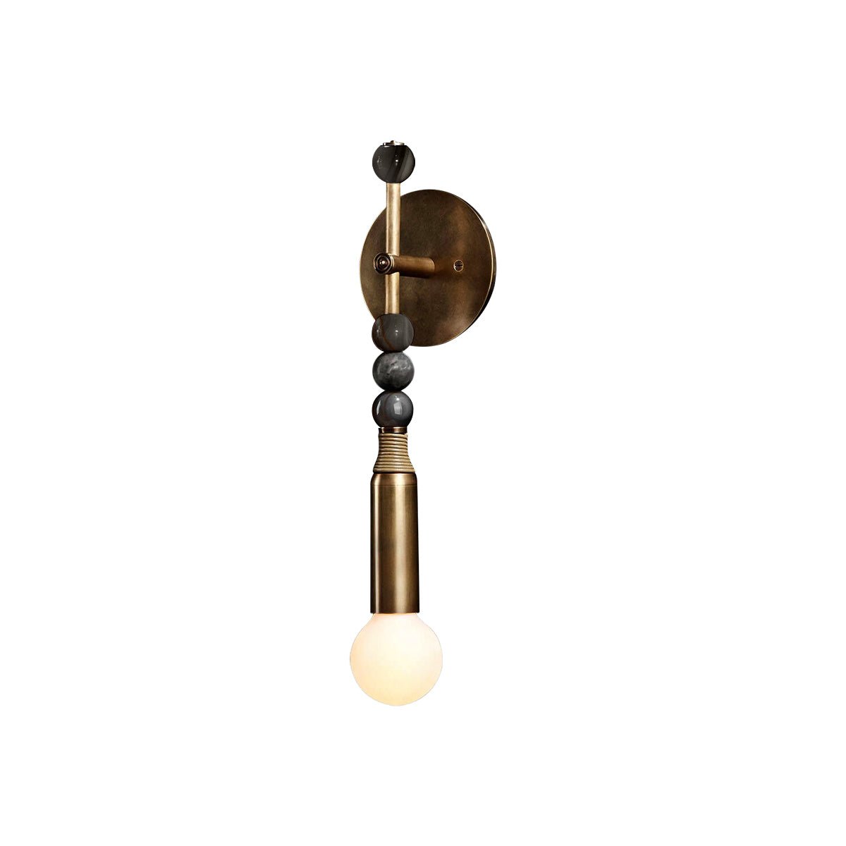 Antique brass wall lamp with marble accent glowing warmly