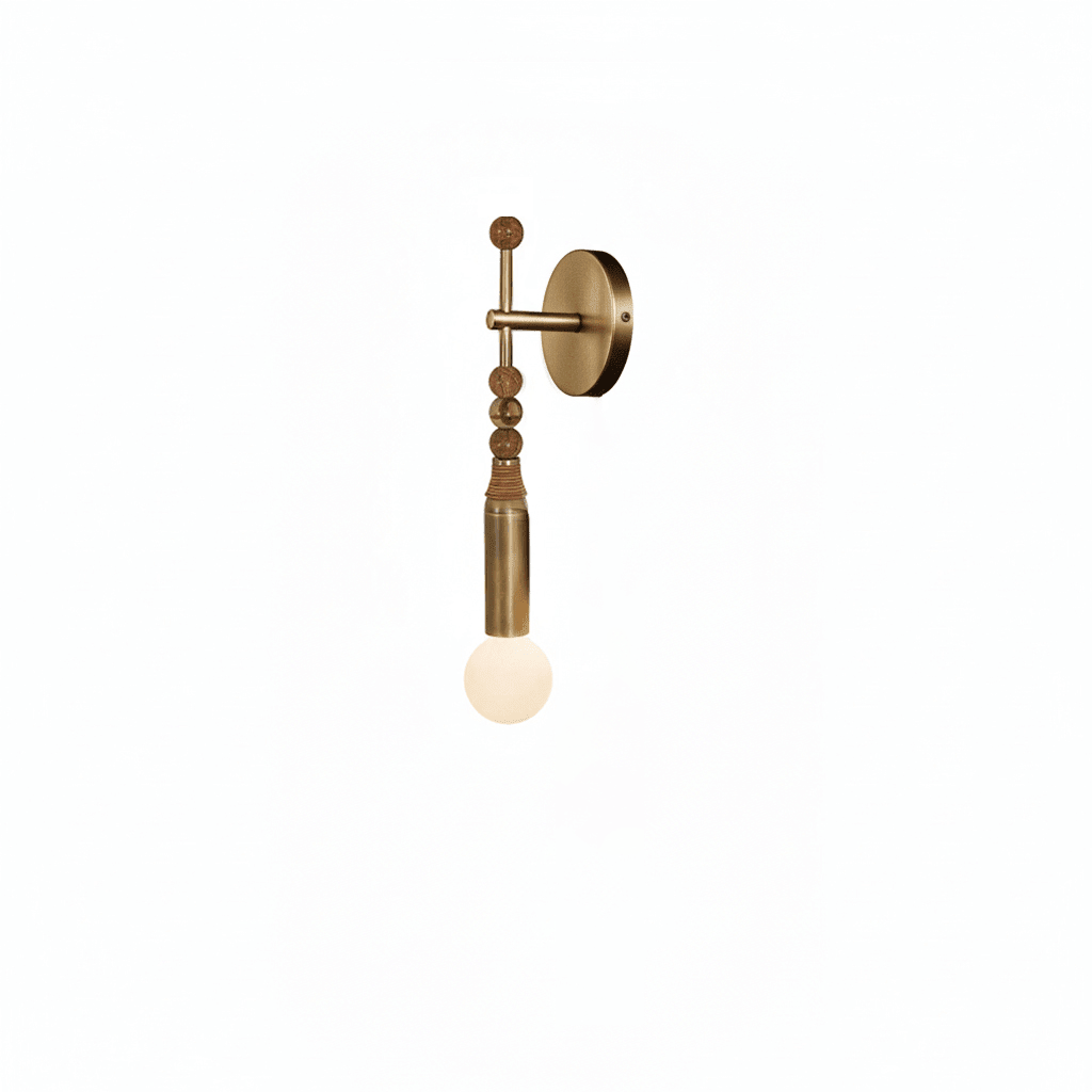 Brass wall lamp with white marble detail against a wall