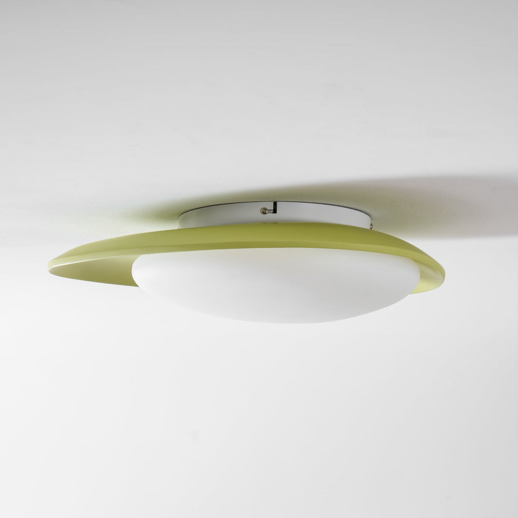 Mounted flush with its fixing points visible, this Clérachic ceiling light shows its green rim and diffuser from below.