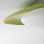 Close view of the edge where the green resin shell meets the white diffuser on this Clérachic ceiling light.